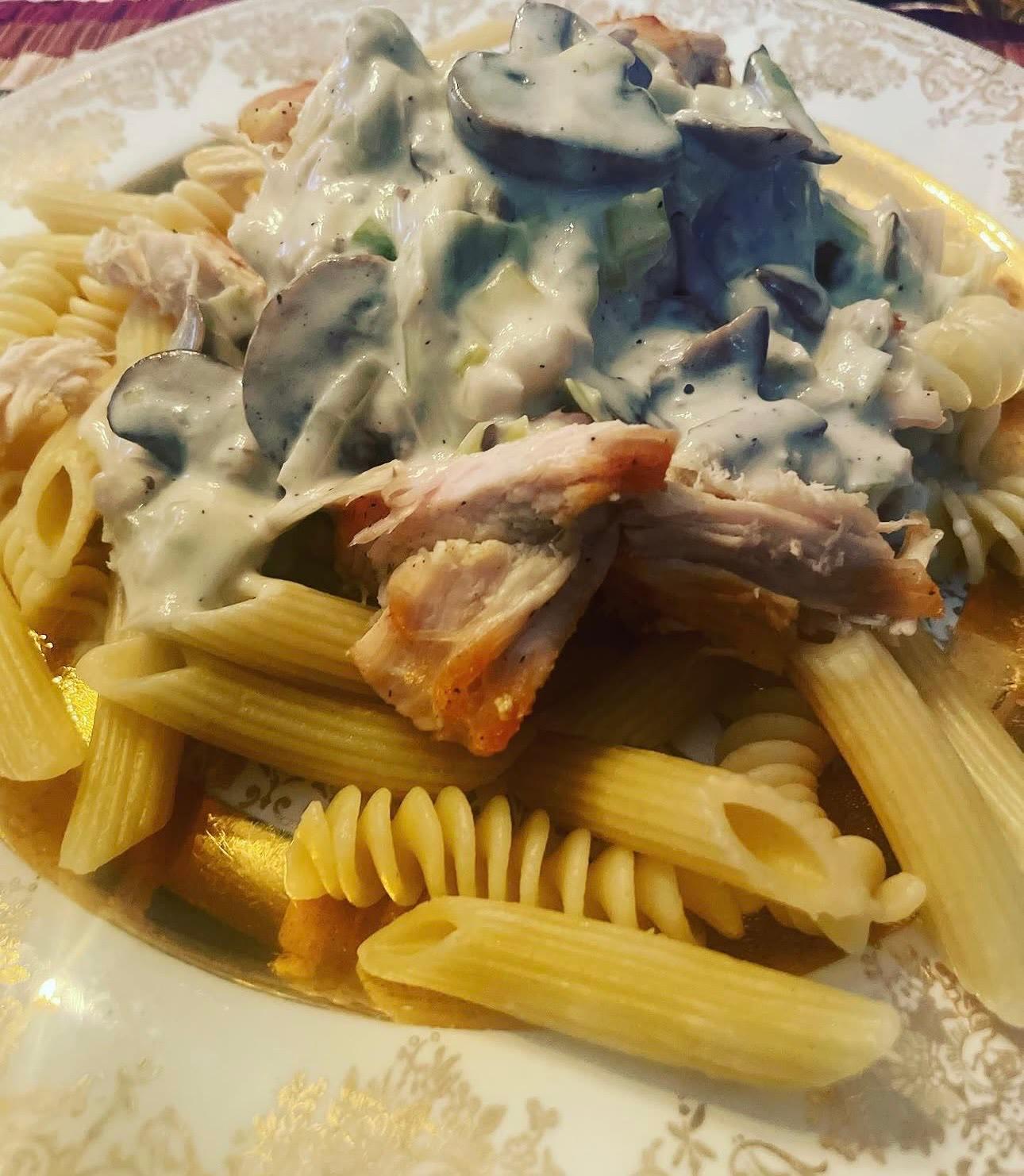 Pasta in a cream sauce with chicken and vegetables